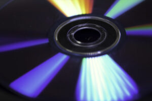 Background of compact disks or dvds. Glare of light on the disk DVD , beautiful colored glare from the light, the background disk DVD