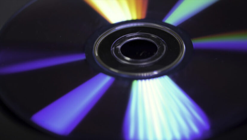 Background of compact disks or dvds. Glare of light on the disk DVD , beautiful colored glare from the light, the background disk DVD